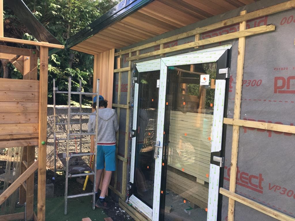 Installing cedar cladding on garden room